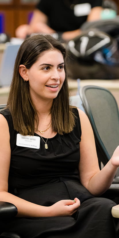 Woman talking in class as part of the Kellogg MiM program.